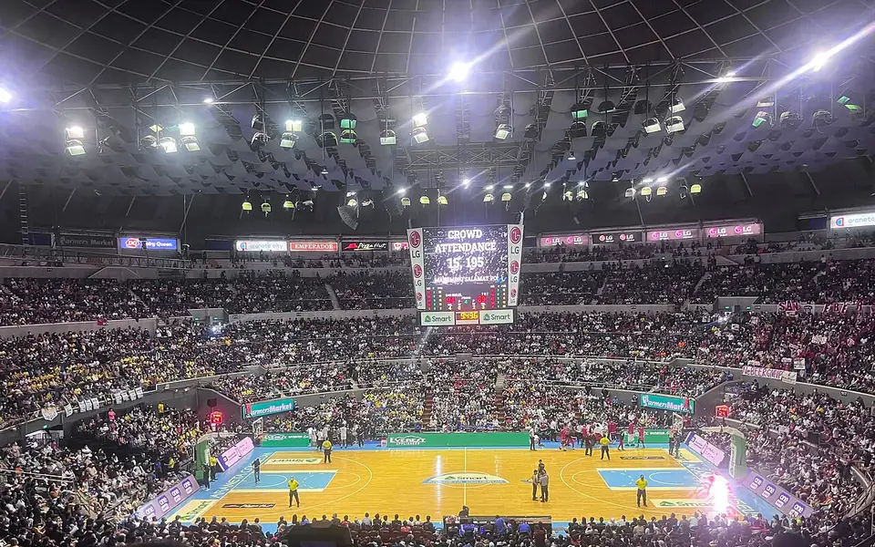 Filipino basketball fans filling an arena during the PBA finals
